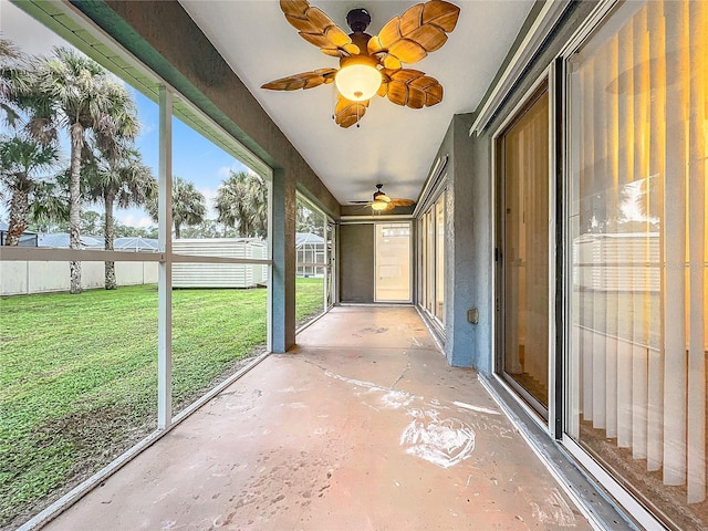 unfurnished sunroom with a ceiling fan