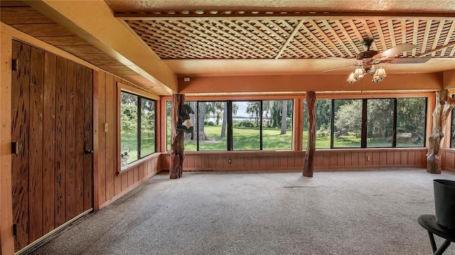 unfurnished sunroom featuring ceiling fan