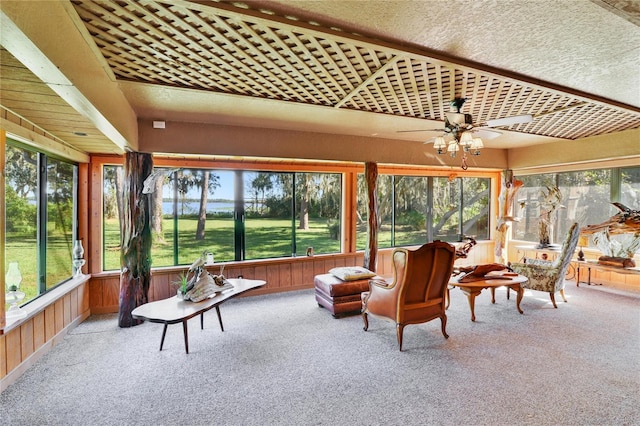 sunroom / solarium with a ceiling fan