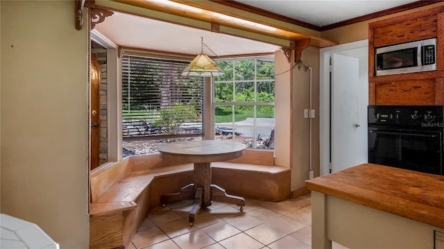 dining area featuring light tile patterned floors and ornamental molding