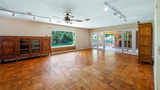 unfurnished living room featuring french doors, visible vents, ceiling fan, and baseboards