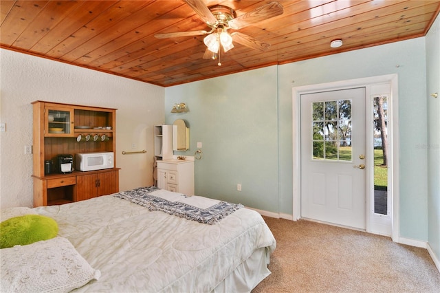 bedroom featuring carpet floors, wooden ceiling, crown molding, and baseboards