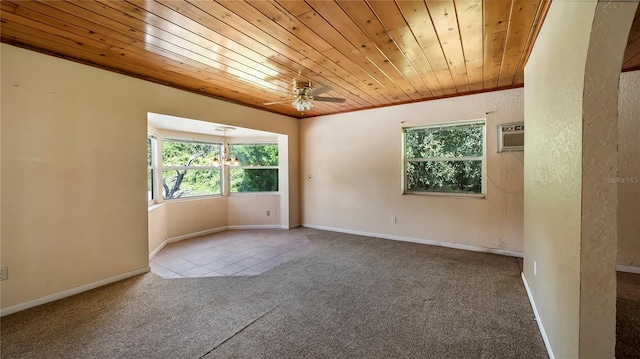 unfurnished room with wooden ceiling, carpet floors, baseboards, ornamental molding, and a wall mounted air conditioner