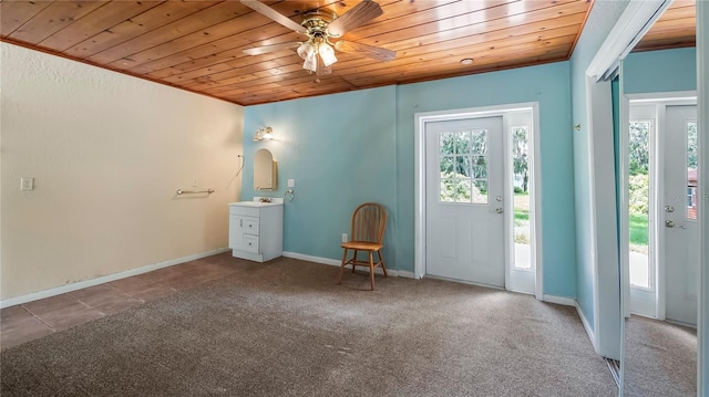 entrance foyer featuring wooden ceiling, baseboards, a ceiling fan, and carpet flooring