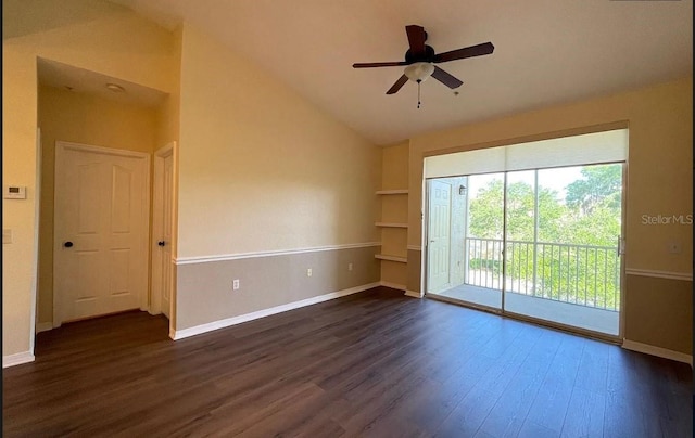 empty room with lofted ceiling, ceiling fan, and dark hardwood / wood-style floors