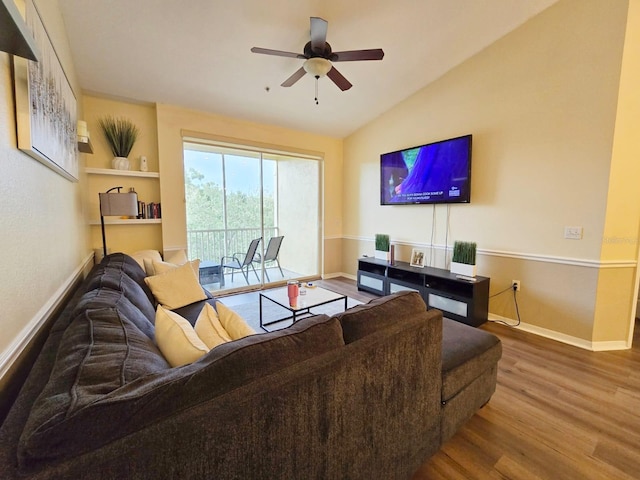 living room with lofted ceiling, hardwood / wood-style floors, and ceiling fan