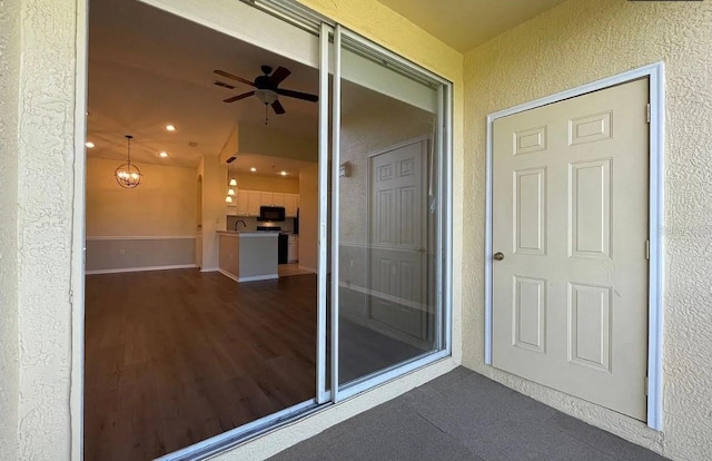 entrance to property featuring ceiling fan