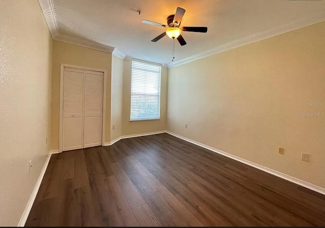 unfurnished bedroom featuring a closet, ceiling fan, dark hardwood / wood-style floors, and ornamental molding