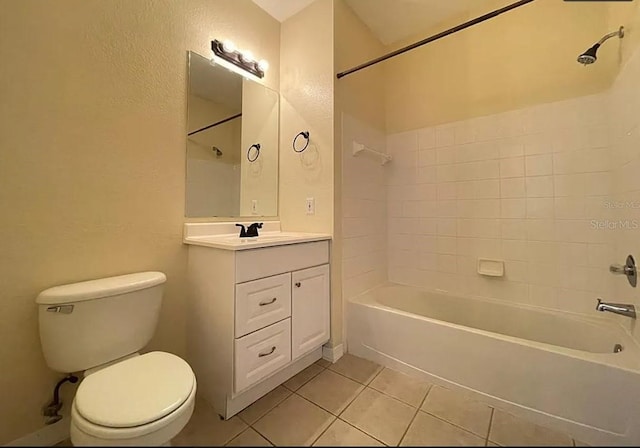 full bathroom featuring vanity, toilet, tiled shower / bath combo, and tile patterned floors