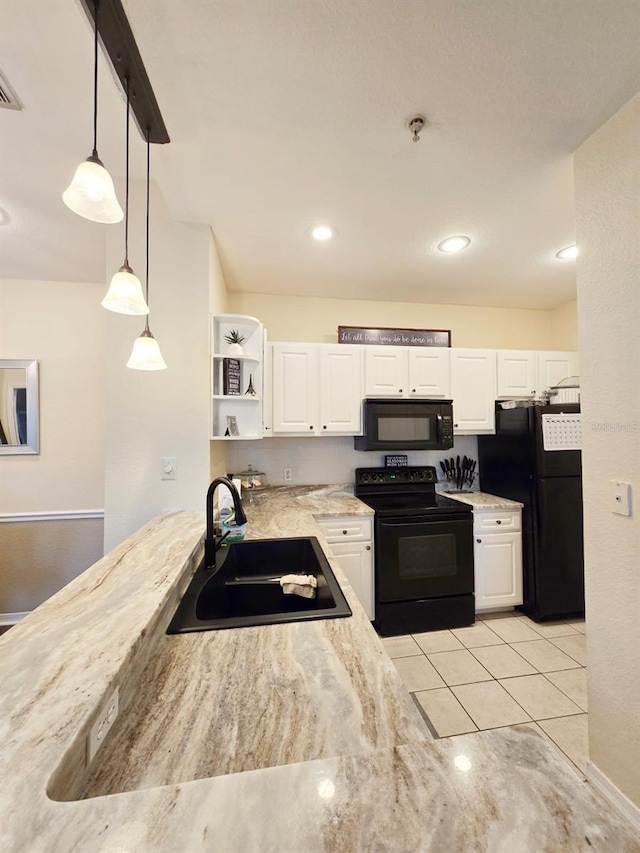 kitchen featuring black appliances, pendant lighting, light tile patterned floors, sink, and white cabinetry