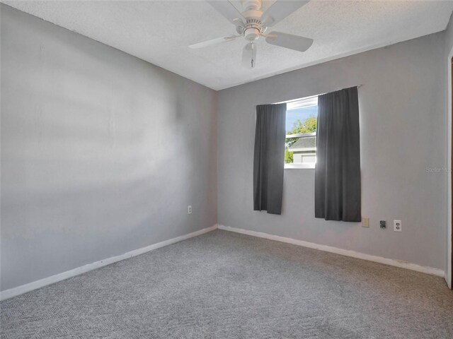 empty room with ceiling fan, a textured ceiling, and carpet floors