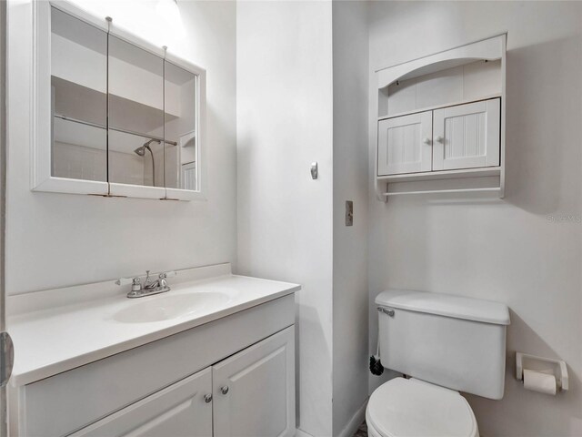 bathroom with toilet and vanity