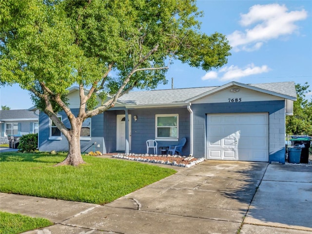 single story home featuring a garage and a front yard