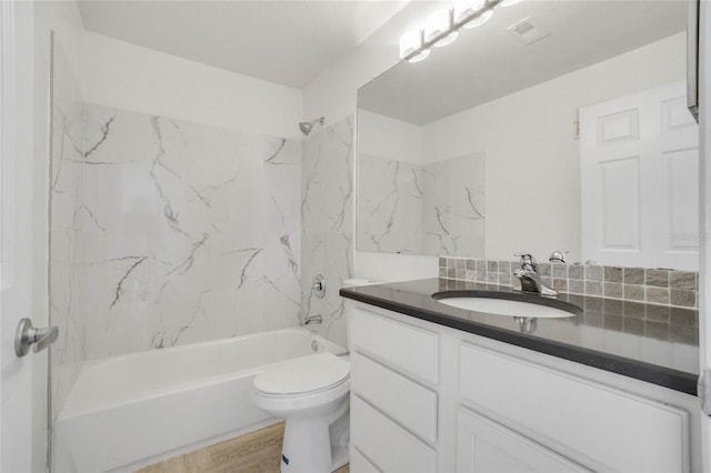 bathroom featuring visible vents, toilet, shower / tub combination, wood finished floors, and vanity