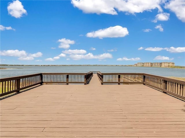 view of dock with a deck with water view