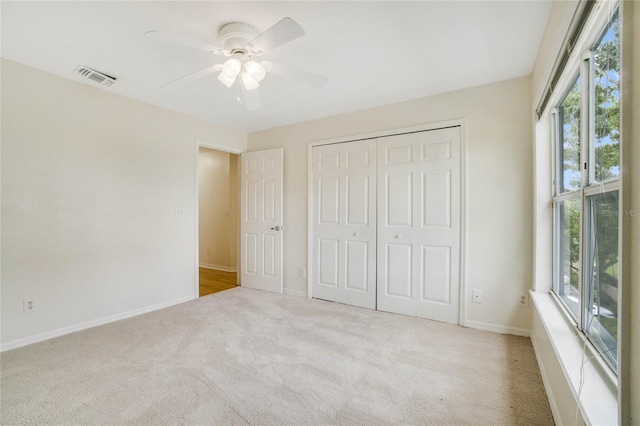 unfurnished bedroom with visible vents, ceiling fan, baseboards, carpet floors, and a closet