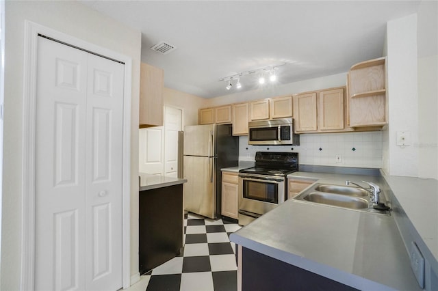 kitchen featuring light tile patterned flooring, sink, appliances with stainless steel finishes, decorative backsplash, and light brown cabinets