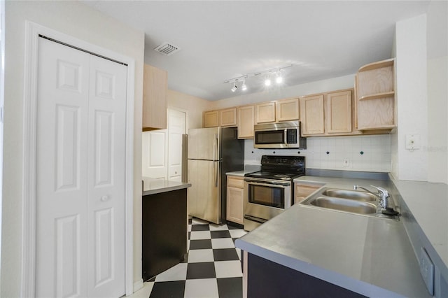 kitchen with light floors, visible vents, a sink, light brown cabinetry, and stainless steel appliances