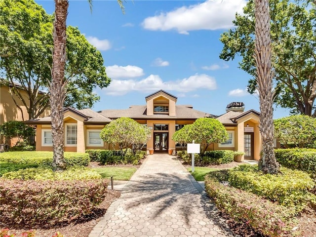 view of front of property with french doors and stucco siding