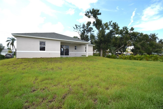 back of property featuring a lawn