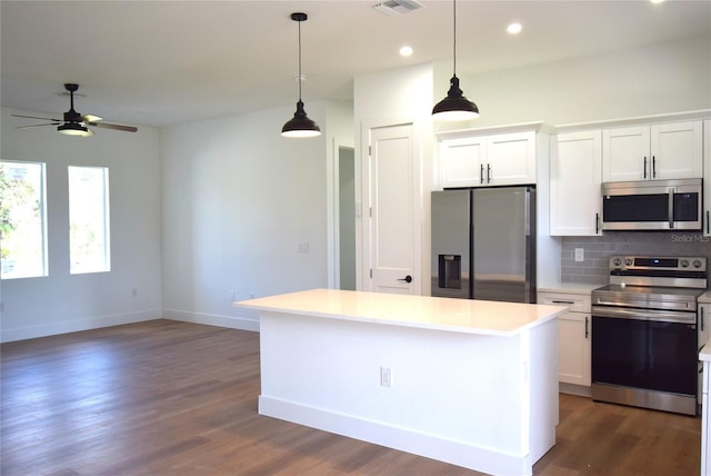 kitchen with hanging light fixtures, white cabinetry, appliances with stainless steel finishes, and a center island