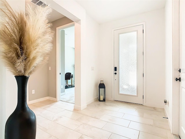 entryway featuring light tile patterned floors