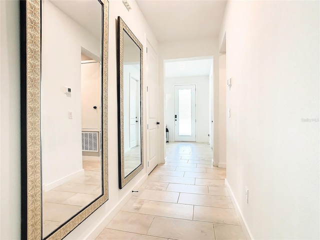 hallway with light tile patterned floors