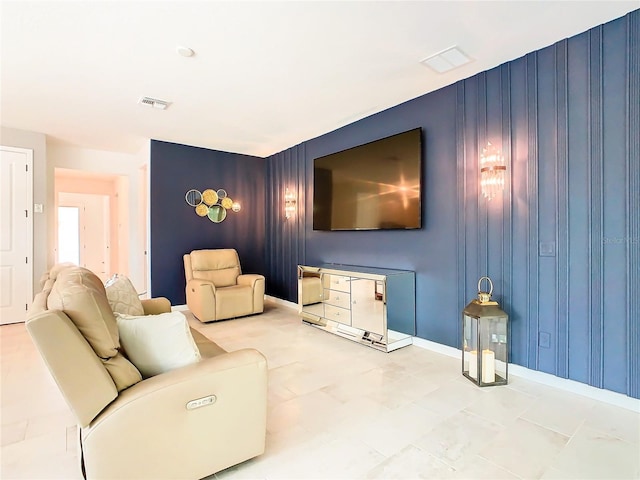 living room featuring wooden walls and light tile patterned flooring