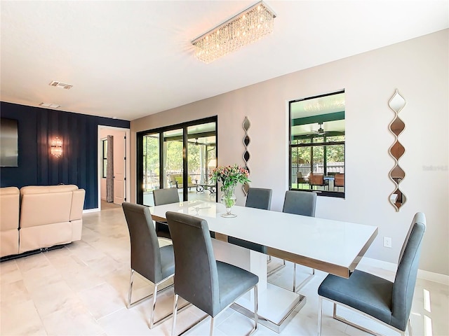 tiled dining space with ceiling fan and plenty of natural light