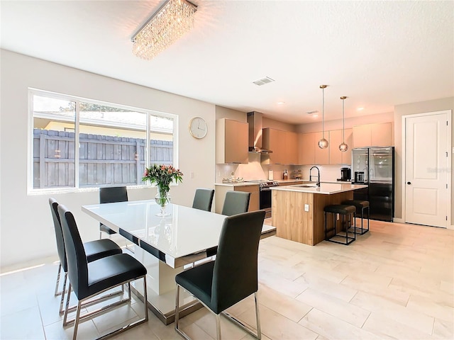 tiled dining room featuring sink