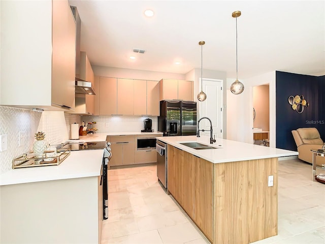 kitchen featuring sink, decorative backsplash, an island with sink, and light tile patterned floors