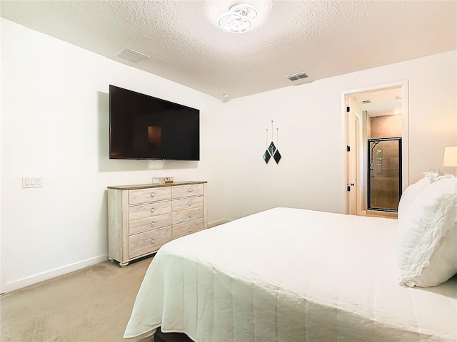 bedroom with a textured ceiling and light colored carpet