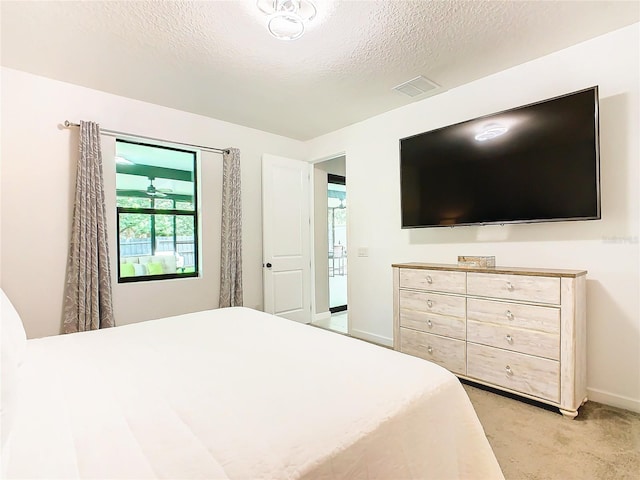 carpeted bedroom with a textured ceiling