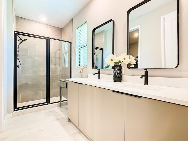 bathroom featuring a shower with shower door, vanity, and tile patterned floors