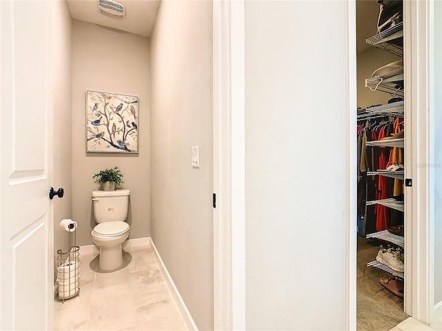 bathroom featuring tile patterned flooring and toilet