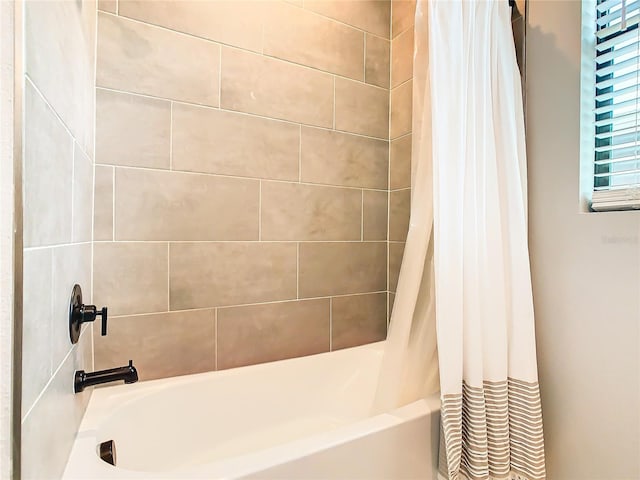 bathroom featuring shower / bath combo with shower curtain