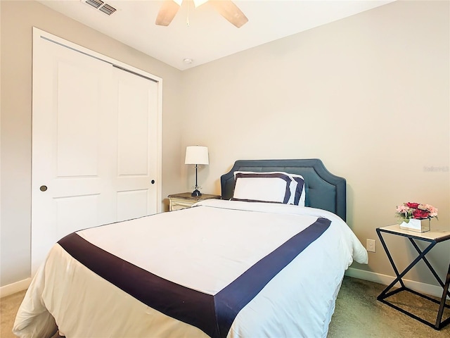 bedroom with ceiling fan, a closet, and light carpet