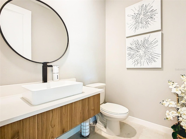 bathroom featuring tile patterned floors, vanity, and toilet