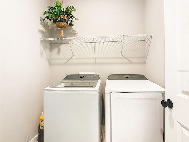 washroom with washing machine and clothes dryer