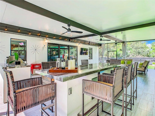 exterior space with ceiling fan and exterior bar