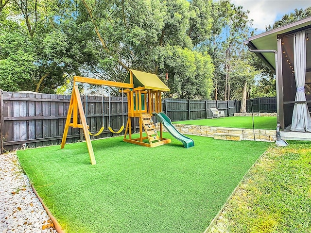 view of playground with a lawn