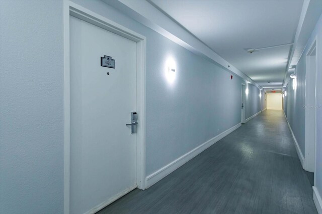 hallway with dark wood-type flooring