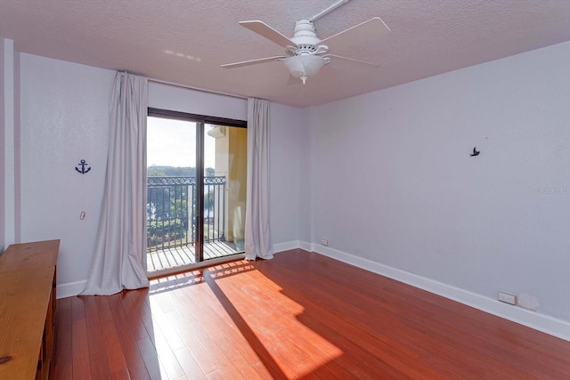 spare room with a textured ceiling, ceiling fan, and hardwood / wood-style flooring