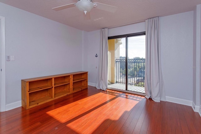 spare room with wood-type flooring and ceiling fan