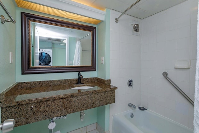 bathroom with tiled shower / bath combo and sink