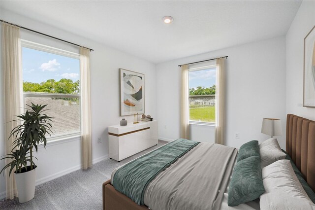 bedroom featuring baseboards and light colored carpet