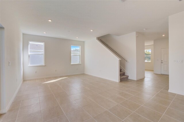 interior space featuring stairs, light tile patterned floors, baseboards, and recessed lighting