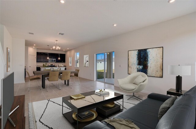 living area featuring recessed lighting, light tile patterned flooring, visible vents, and an inviting chandelier