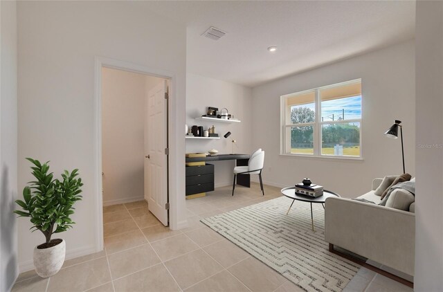 office featuring light tile patterned flooring, visible vents, and baseboards