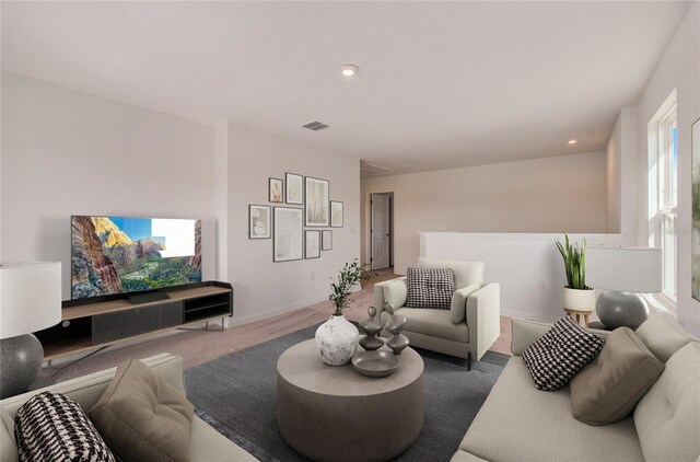 carpeted living area featuring baseboards, visible vents, and recessed lighting